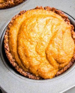 Close up of a mini pumpkin pie in a muffin tin.