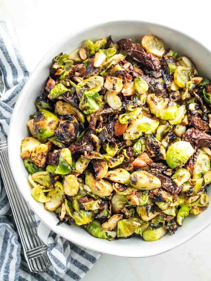 Crispy brussels sprouts with sundried tomatoes and chopped almonds.