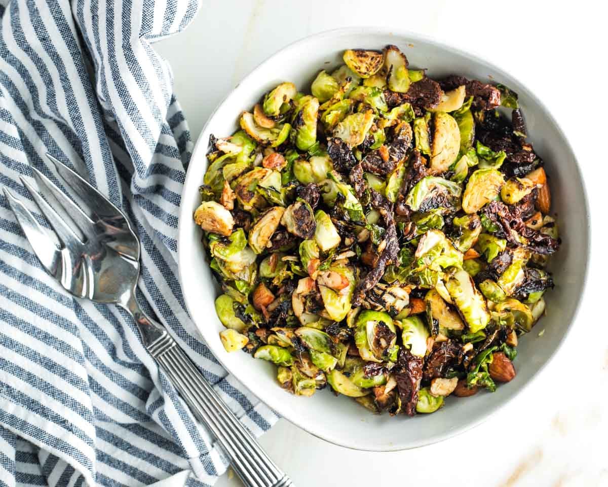 Crispy brussels sprouts with sundried tomatoes and chopped almonds.