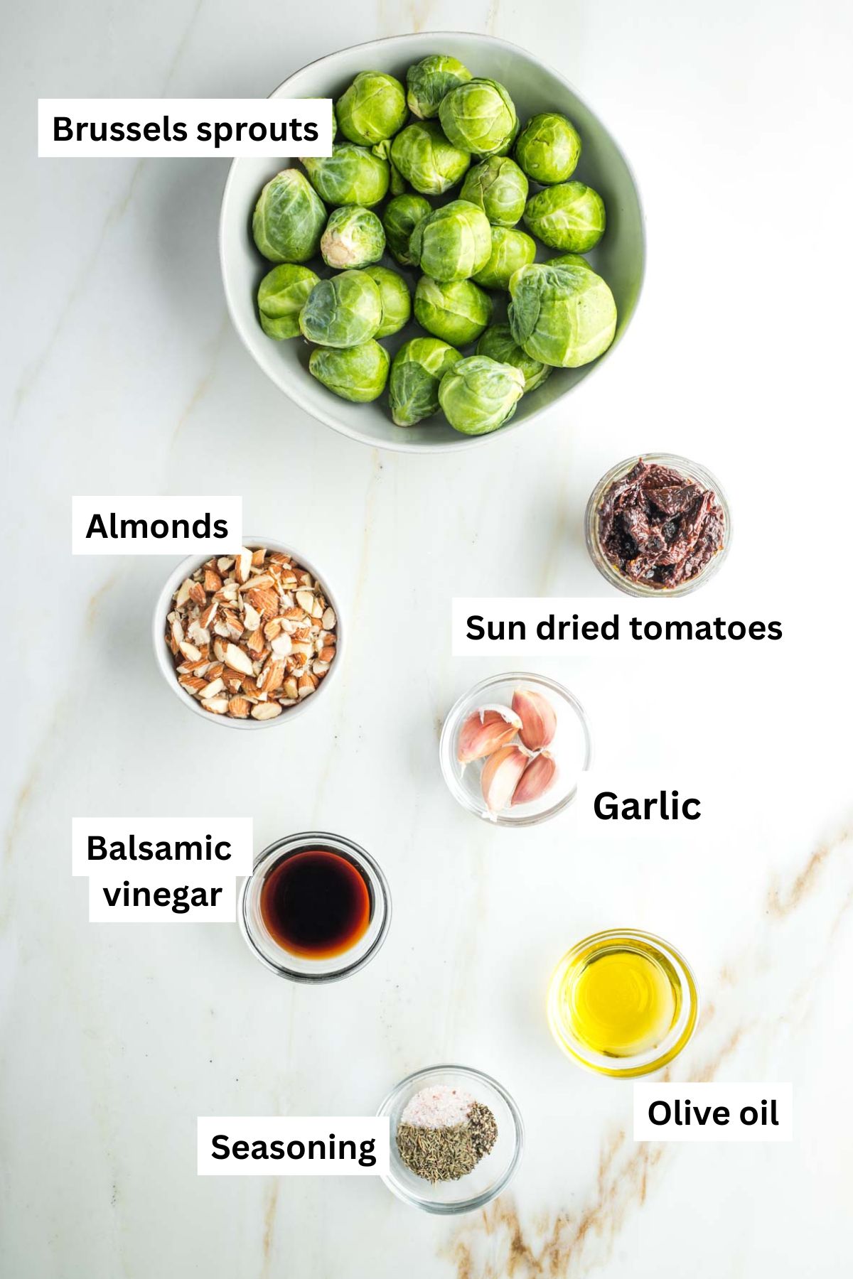 Labeled ingredients: brussels sprouts, sun dried tomatoes, almonds, balsamic vinegar, olive oil, spices, garlic. 