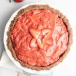Strawberry pie with nut crust in a ceramic pie plate