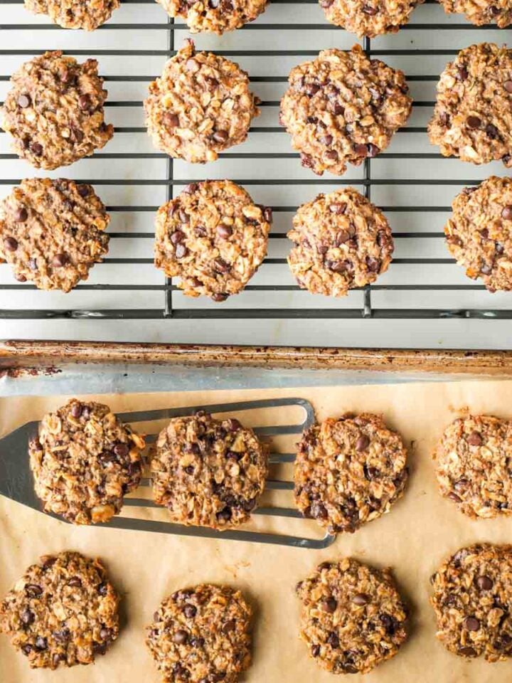 Spatula transferring cookies onto a wire cooling rack.