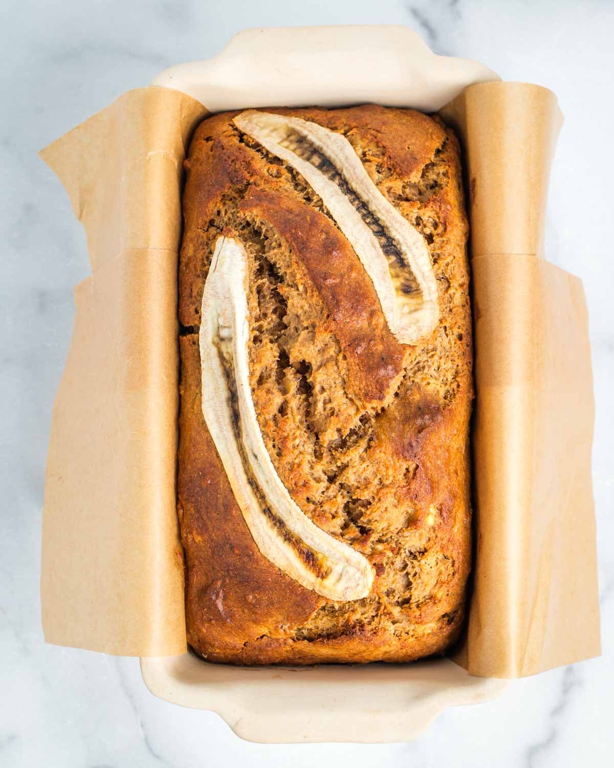 Fresh out of the oven, crisp on top, loaf of banana bread. 