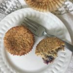 white plate blueberry muffin cut open.