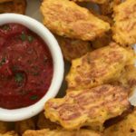 Sweet potato and cauliflower tater tots with ketchup.