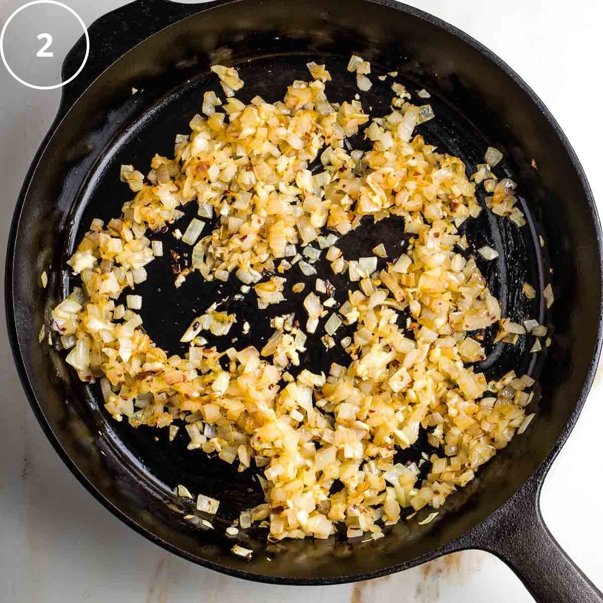 Browned diced onions in a cast iron skillet.