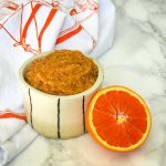 Halved orange plus a dish with thick orange marmalade.