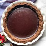 Pecan and date crust filled with chocolate pudding for a chocolate pie.