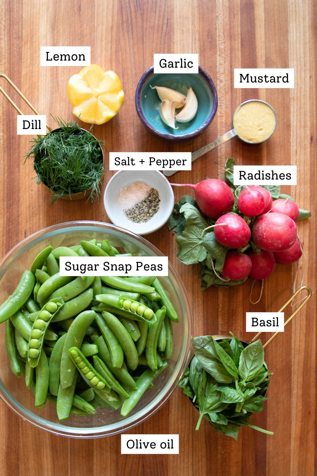 Ingredients: lemon, garlic, mustard, fresh dill, fresh basil, radishes, snap peas, olive oil, salt and pepper.
