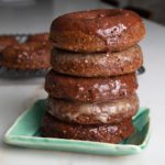 Pile of pumpkin donuts with maple or chocolate glaze dripping down.