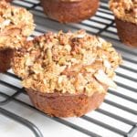 Close up of a pumpkin muffin with streusel topping on a wire cooling rack