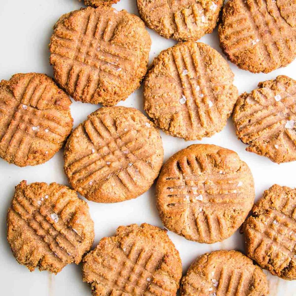 Peanut butter cookies with cross hatch fork marks. 