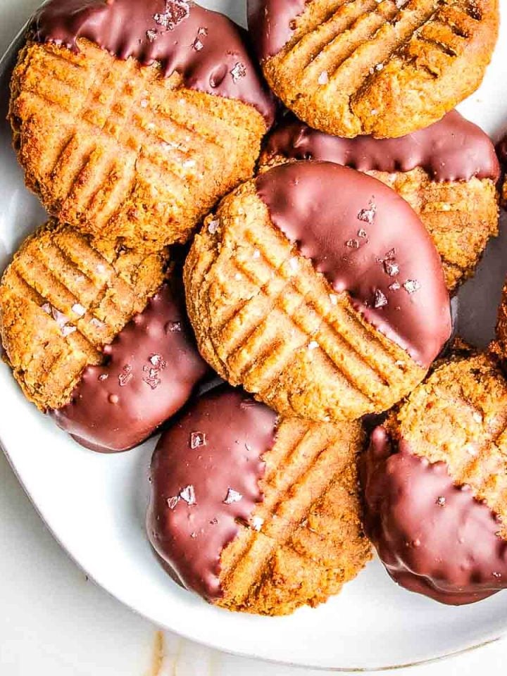 Peanut butter cookies with fork marks, dipped in dark chocolate and sprinkled with flakey salt.