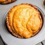 Close up of a mini pumpkin pie in a muffin tin.