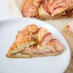 Side view of a slice of apple galette. You can see all the layers of apple slices.