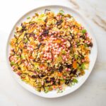 Jeweled rice with colorful pomegranate, caramelized onions, carrots, nuts and scallions.