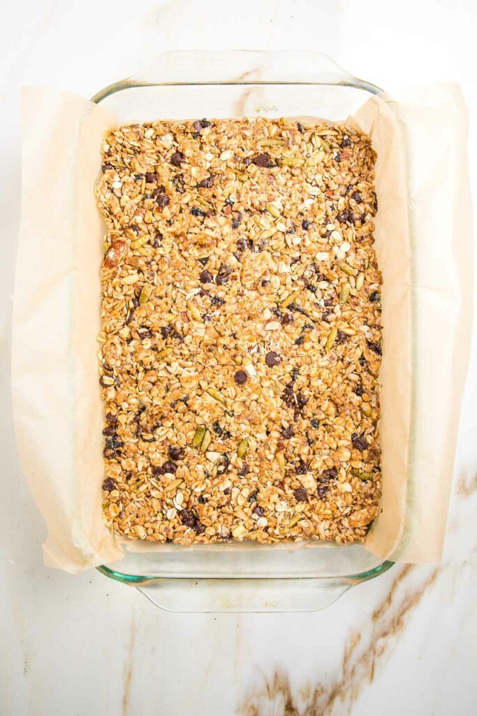 granola bars in a glass dish lined with parchment