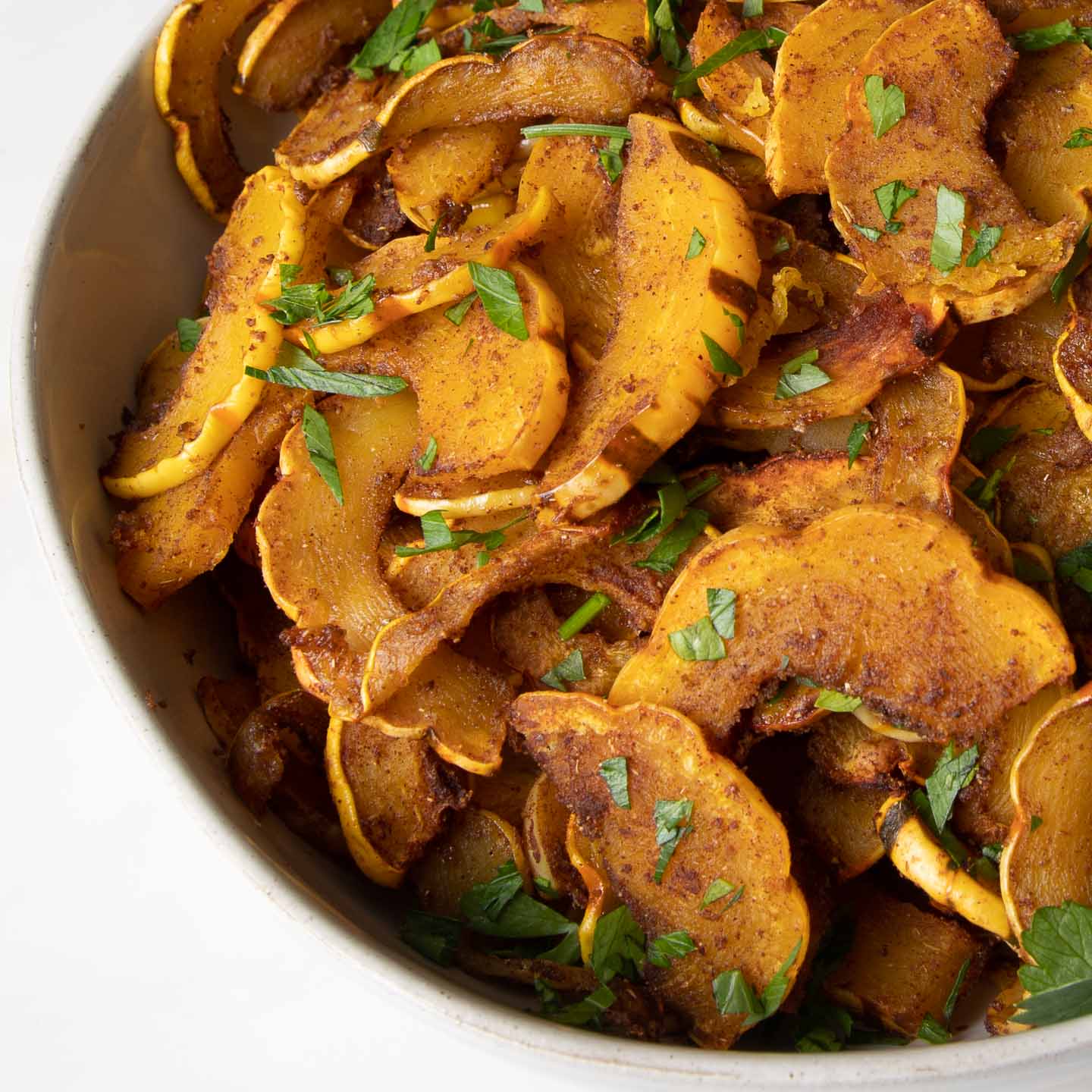 Delicata squash half moons, roasted with spices.