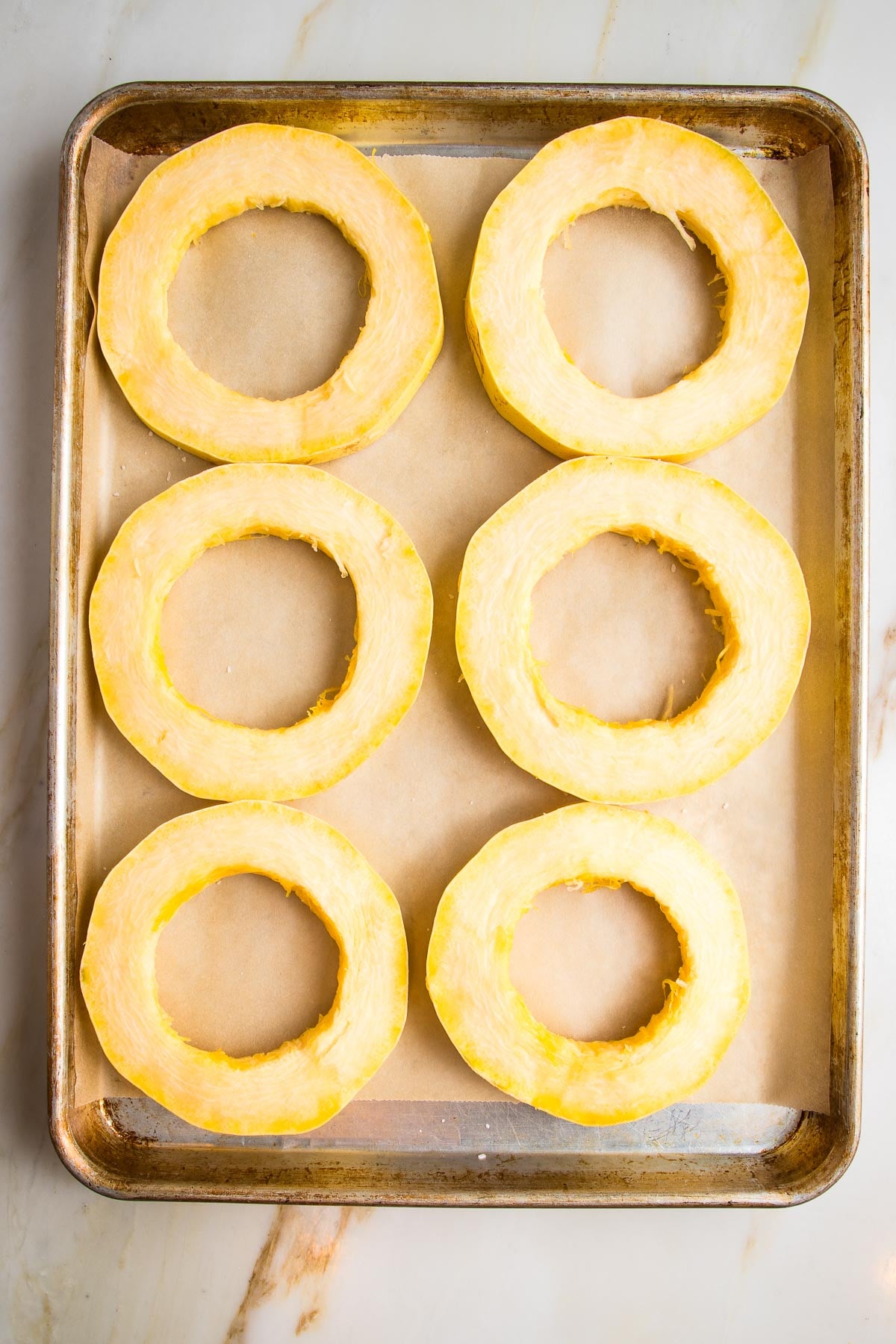 Spaghetti Squash Rings on a parchment lined baking tray