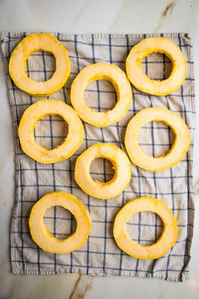 Spaghetti Squash Rings sprinkled with kosher salt and set on a kitchen towel.