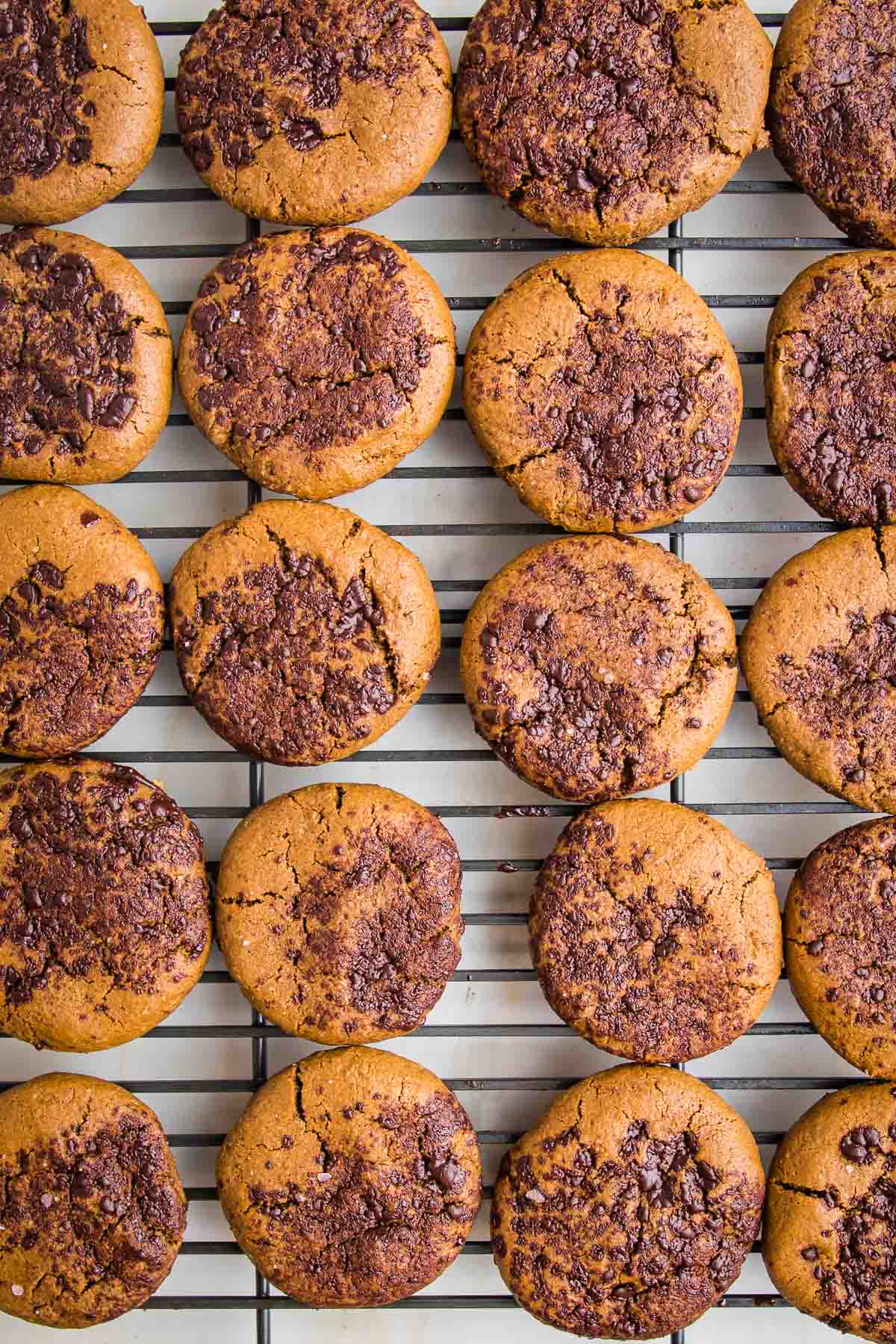 Wire rack loaded with crinkle ginger molasses cookies.