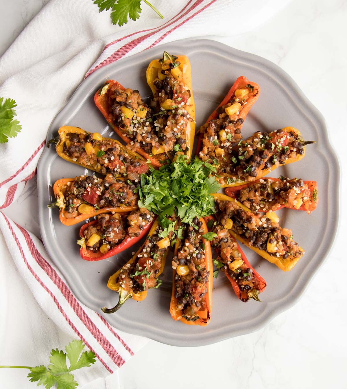 Colorful mini sweet peppers baked with a lentil and cauliflower rice stuffing.