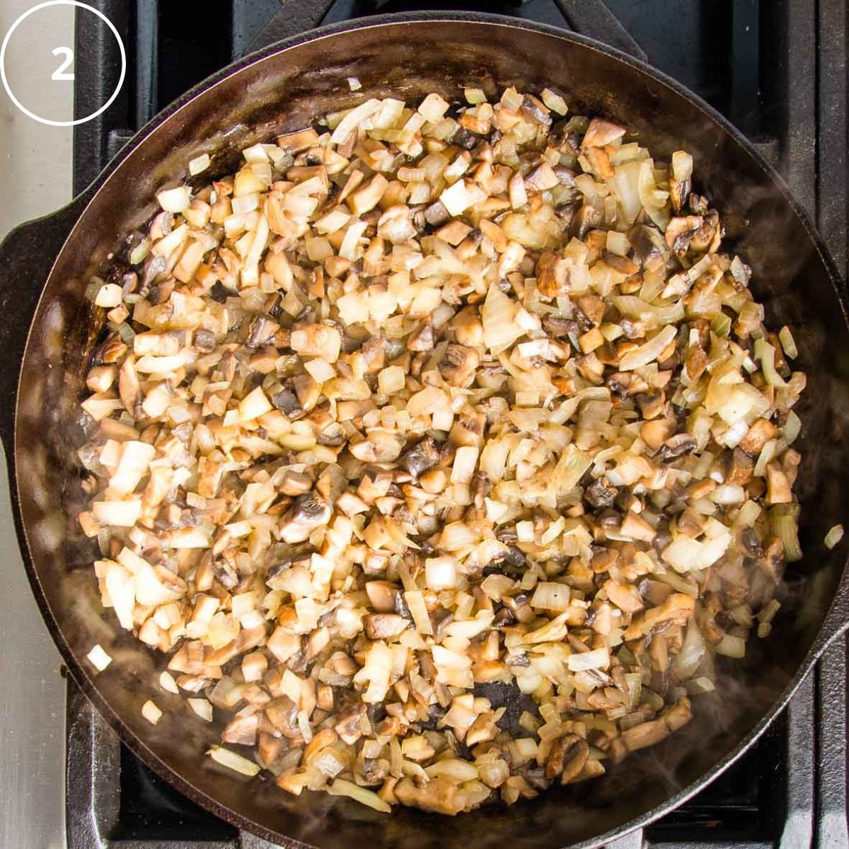 Sauteed onions and mushrooms in a cast iron skillet.