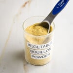 Vegetable Bouillon Powder labeled jar with yellow powdery mix inside plus a Tablespoon measure.