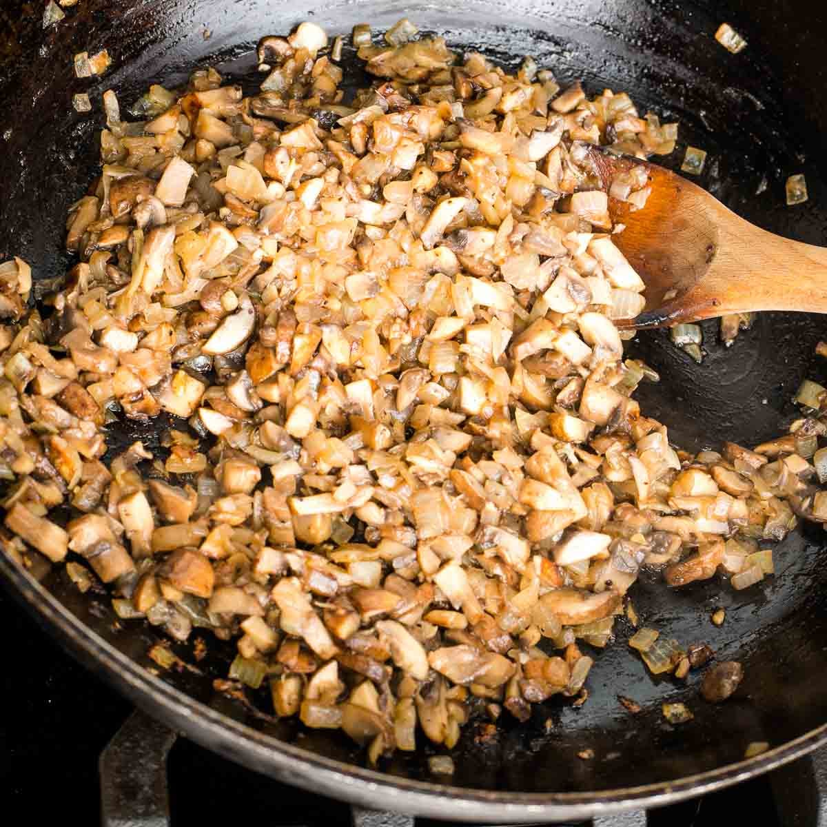 Sauteed mushrooms, onions and garlic in a heavy dark skillet.