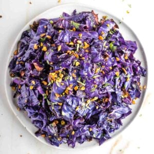 Strips of roasted red cabbage in a beautiful purple hue, sprinkled with pistachios.