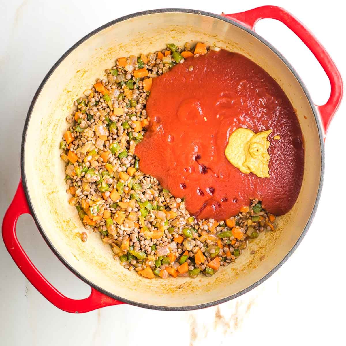 Lentils and sauteed veggies with tomato sauce, mustard and maple syrup on top.