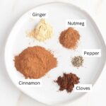 Labeled ingredients for pumpkin pie spice: ginger, nutmeg, pepper, cinnamon, cloves.
