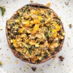 Large portobello mushroom cap stuffed with veggies and herbs.