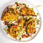 Crispy roasted cauliflower on a bed of hummus, sprinkled with more spices, pine nuts and fresh herbs.