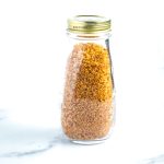 Bottle filled with golden, crispy quinoa.