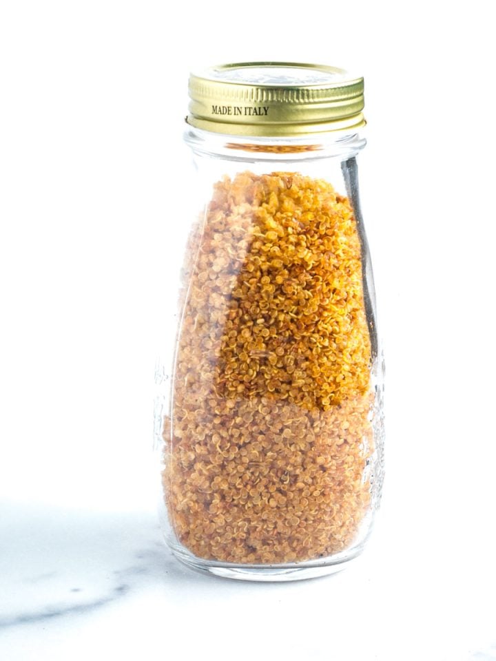 Bottle filled with golden, crispy quinoa.