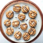 Almond macaroon cookies, bottoms dipped in chocolate and tops decorated with an almond slice and then drizzled with chocolate.