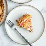 Slices of apple in a custard on top of a walnut tart crust.