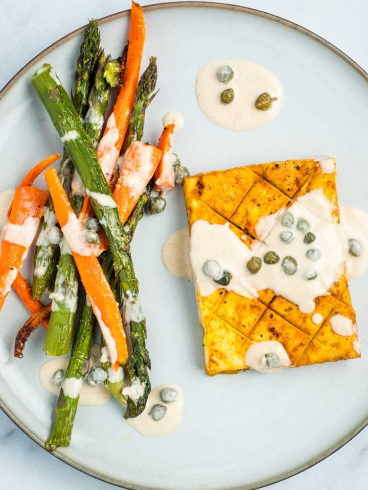 Tofu with lemon caper sauce and a side of carrots and asparagus.