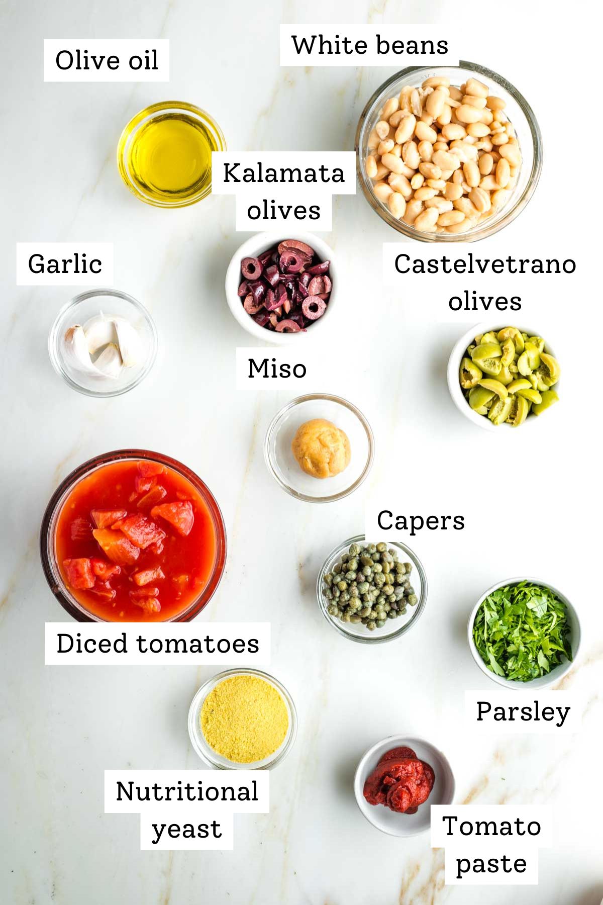 Labeled ingredients for vegan pasta puttanesca.