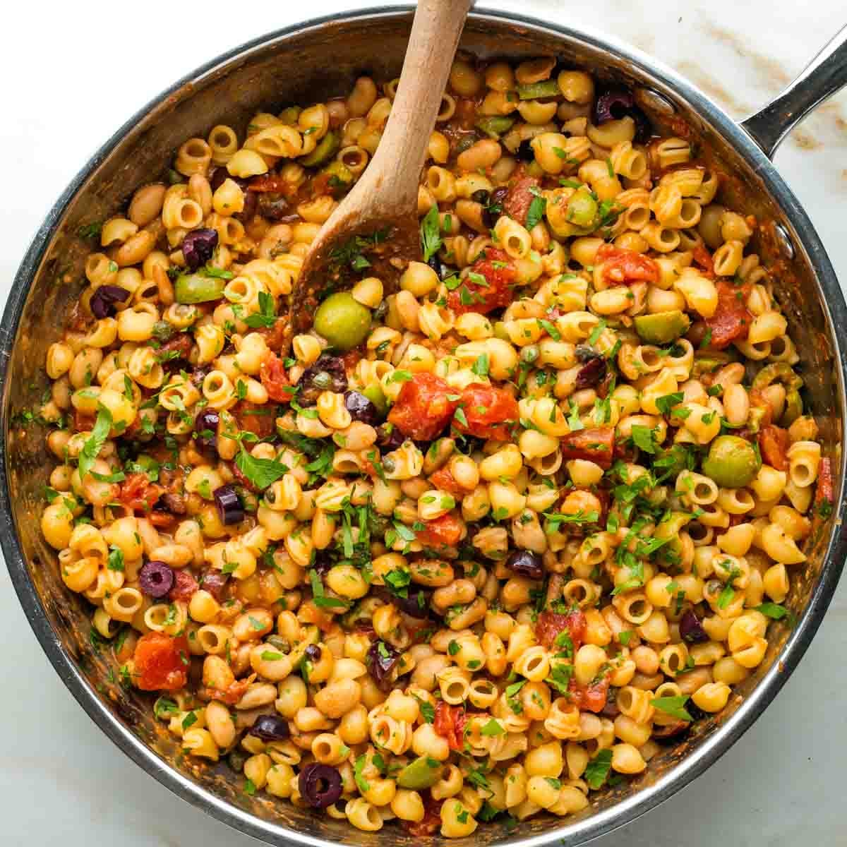White beans, small pasta, black and green olives, plus capers and fresh parsley in a chunky tomato base. 