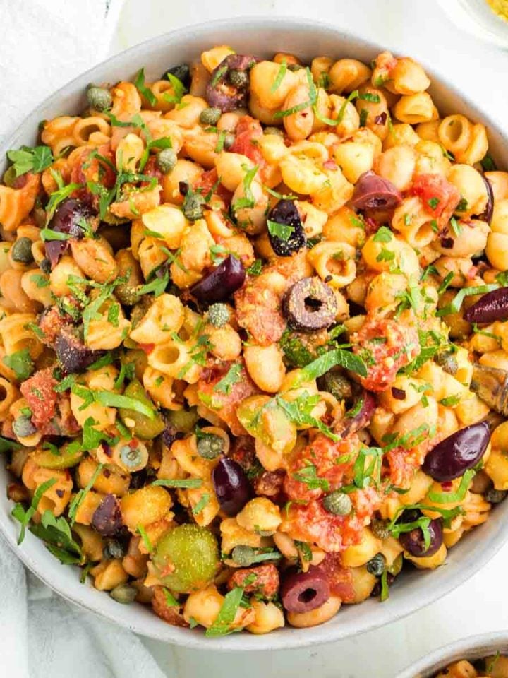 Pasta, white beans, olives and capers with tomatoes and fresh parsley.