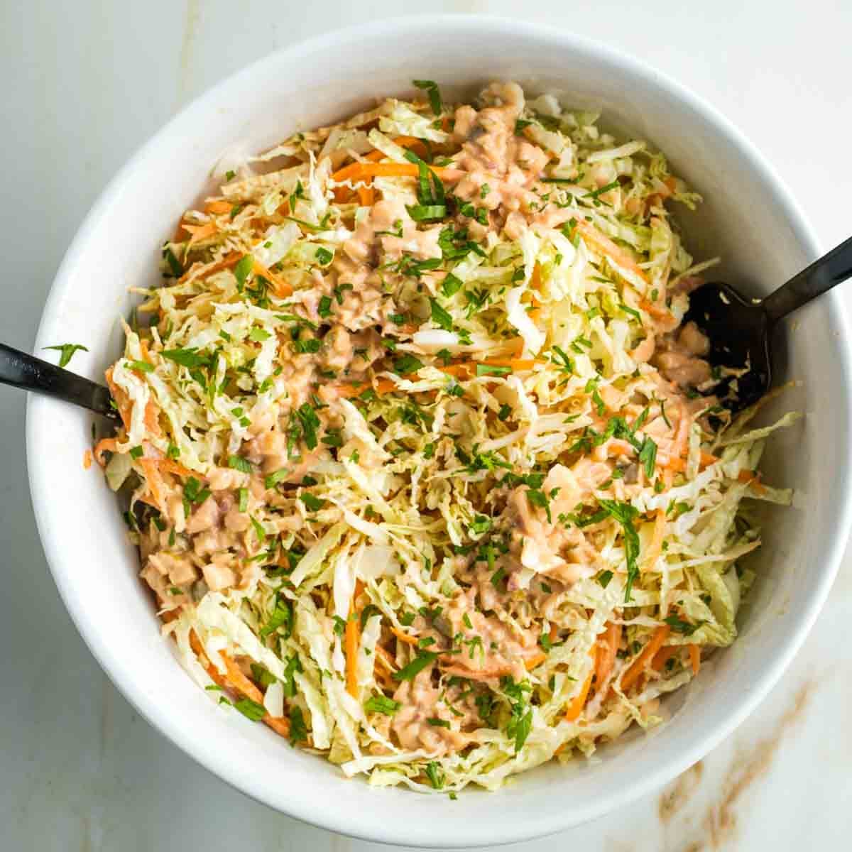 Shredded savoy cabbage and carrots with russian dressing.