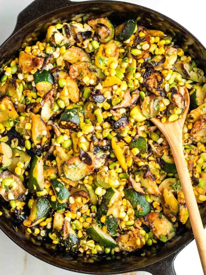 Skillet with zucchini, mushrooms, corn and edamame.