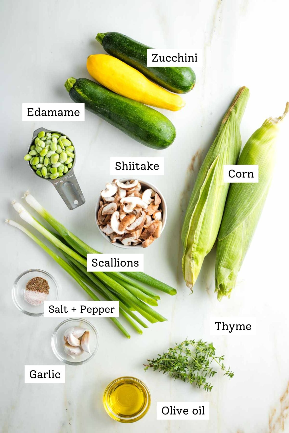 Labeled ingredients: zucchini, edamame, shiitake mushrooms, corn on the cob, slat and pepper fresh thyme, scallions, olive oil, garlic cloves.