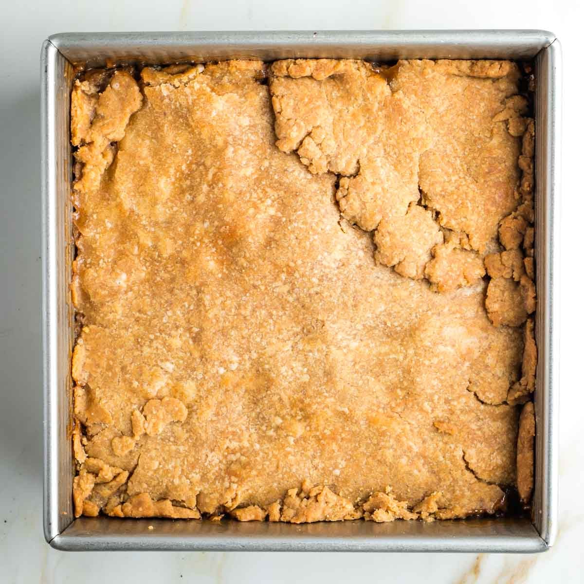 Baked pie with top dough in a square pan.