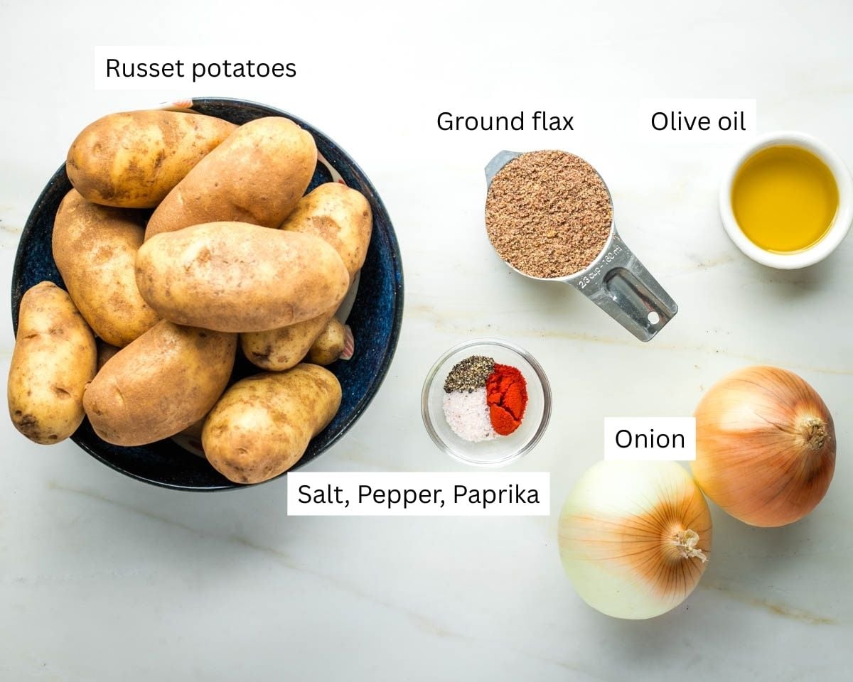 Labeled ingredients for potato kugel: potatoes, spices, onion, olive oil and ground flax.
