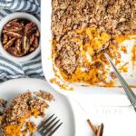 Sweet potato casserole with maple pecan topping, scooped onto a plate.