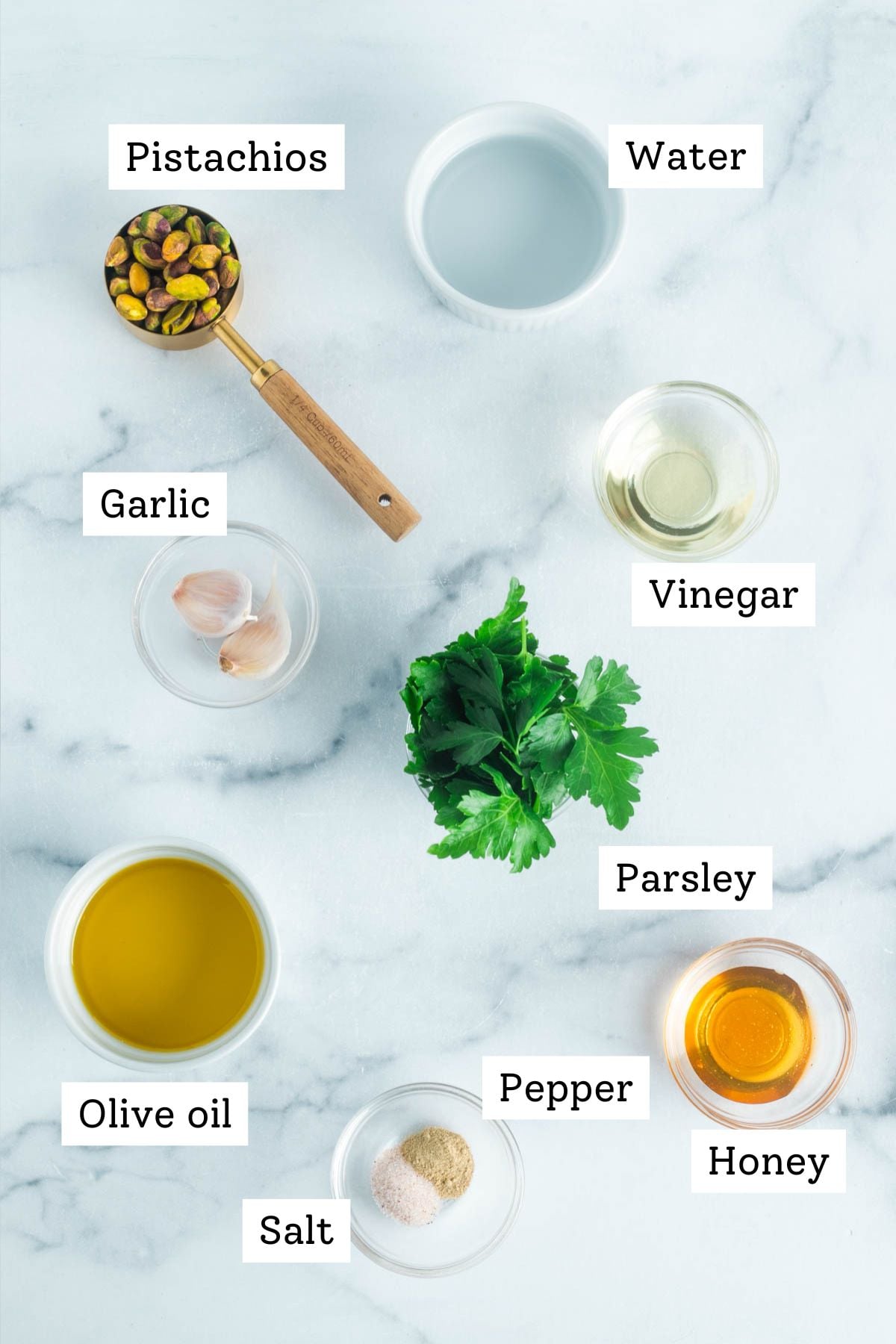 Labeled ingredients for pistachio dressing: pistachios, water, vinegar, garlic, olive oil, honey, parsley, salt and pepper.