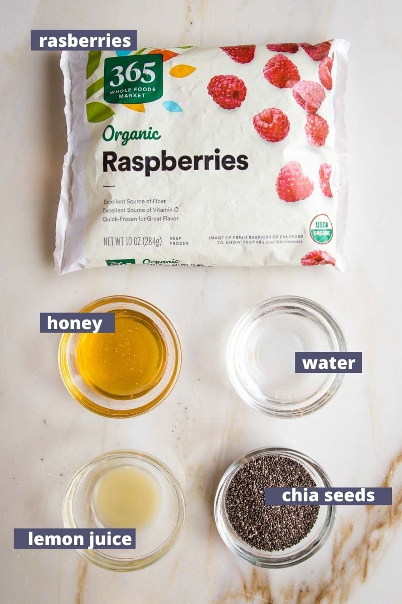 Labeled ingredients for Raspberry Jam: frozen raspberries, honey, water, lemon juice, chia seeds.